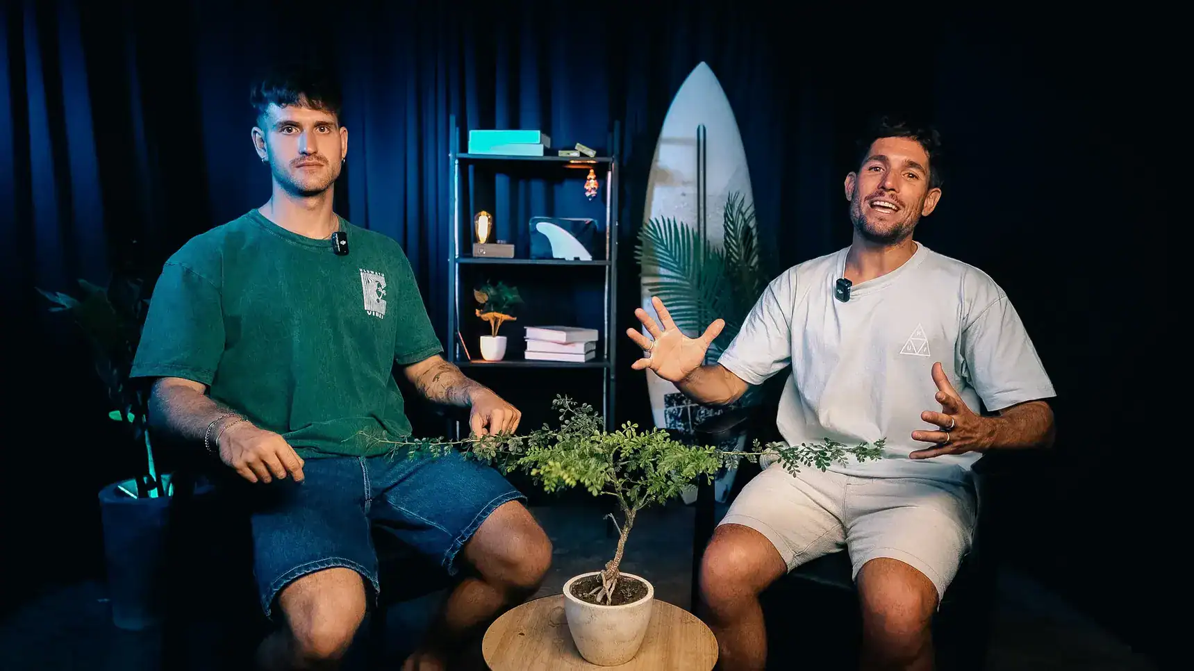 Dynamic image of two men hosting a podcast in a modern, creative studio setting with plants and decor.