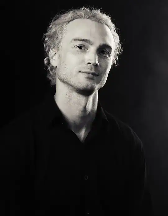1. Black and white portrait of a young man with curly hair and a confident expression.