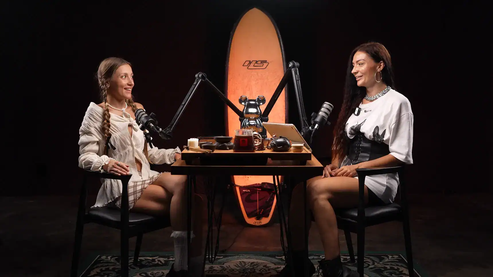 Villo Studio podcast setup with two women, microphones, and creative decor for engaging audio recordings.