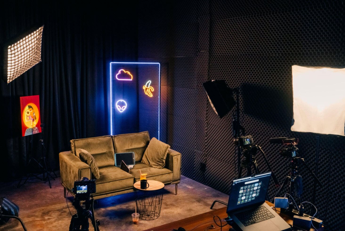 Bright professional recording studio with lighting, soundproof walls, and photo or video setup.