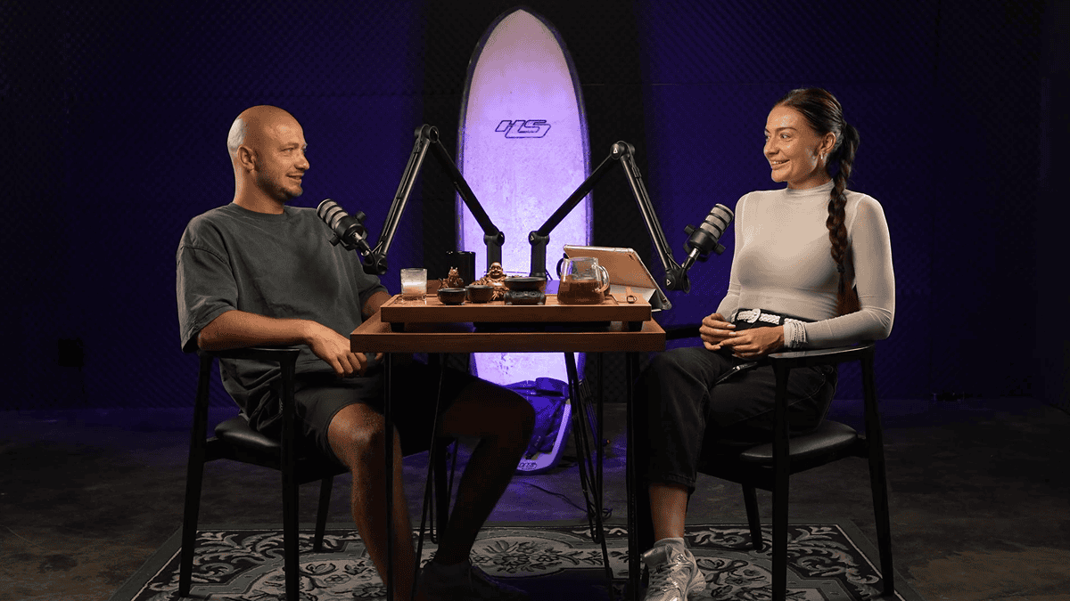 Bespoke podcast studio setup with two hosts, microphones, and modern soundproofing in a stylish environment.