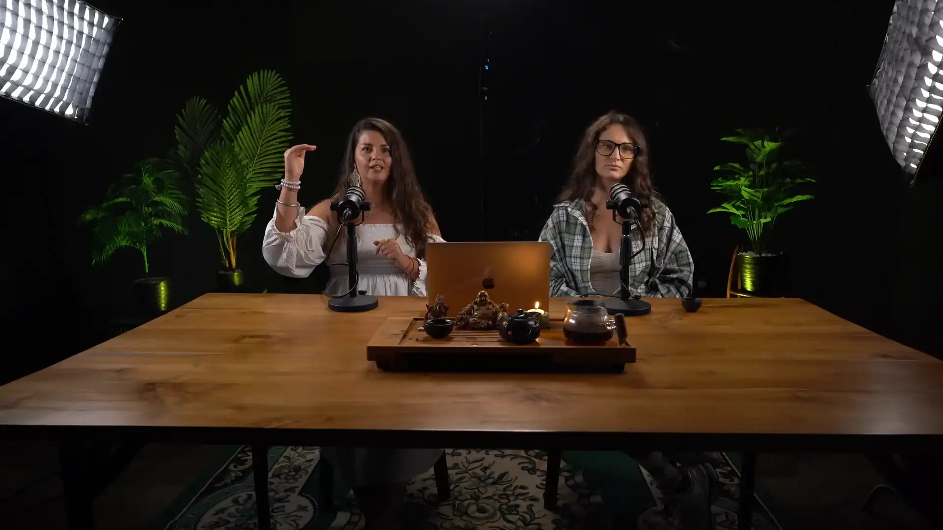Professional podcast recording studio with two women speaking into microphones, creative space for content creation and interviews.